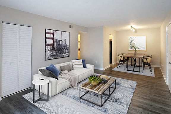 A living room with a white couch and a coffee table.