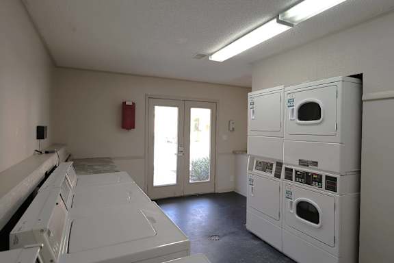A laundry room with washers and dryers.