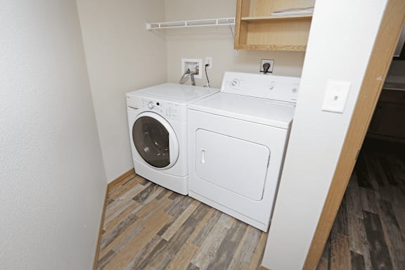 A white washing machine and dryer in a small laundry room.