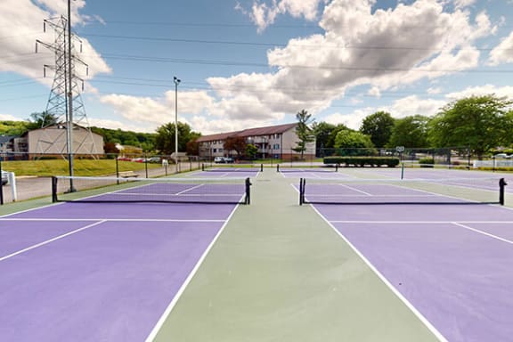 a tennis court with purple and green tennis courts