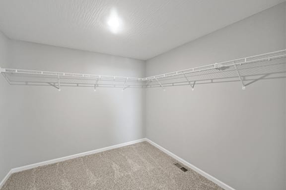 Empty room with white walls and a carpeted floor.
