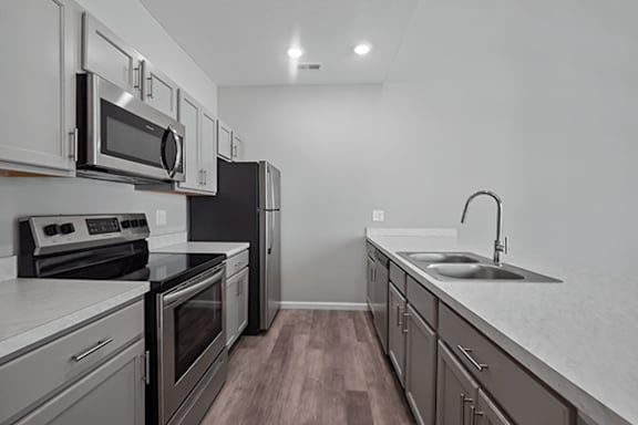 A kitchen with a black refrigerator and stove.