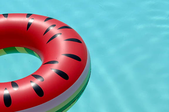 a red lifesaver in a swimming pool