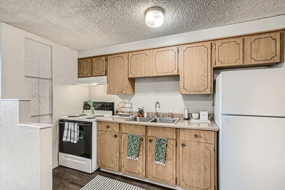 Kitchen equipped with Refrigerator and oven at south federal apartments