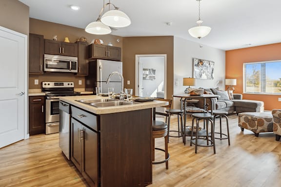 A kitchen with a large island and a dining area.