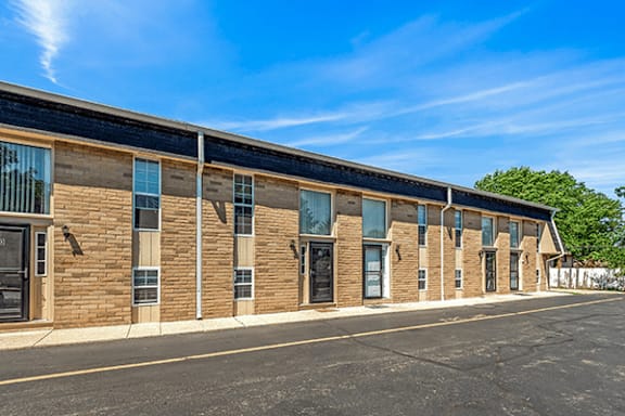 A long building with a black roof and windows on the side.