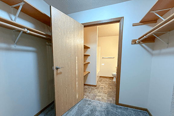 A room with a doorway leading to a bathroom.