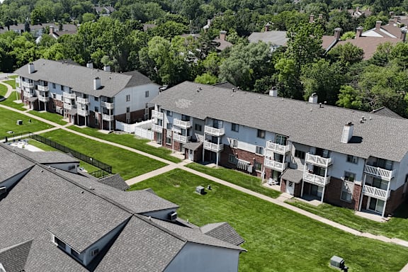 Apartment complex with a green lawn in front.