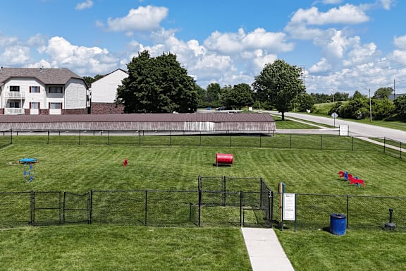 A park with a playground and a baseball field.