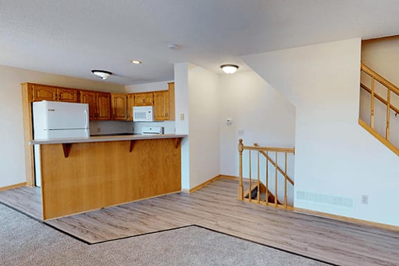 A kitchen with wooden cabinets and a white refrigerator.
