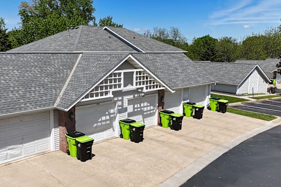 A house with a grey roof and a white garage door.