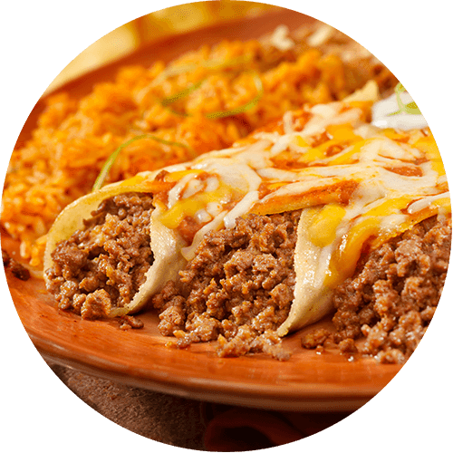 A close up of a plate of food with a meat and cheese topping.