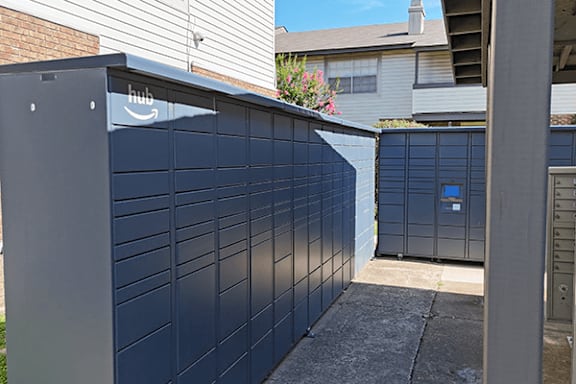 A dark blue wall with a sign that says Amazon hub on it.