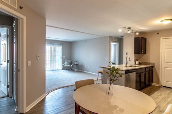 Dining area with kitchen and living areas in the background