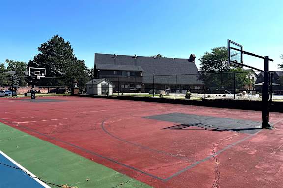 A basketball court with a basketball hoop and a basketball net.
