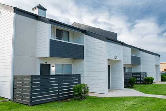 a picture of a white and grey apartment building