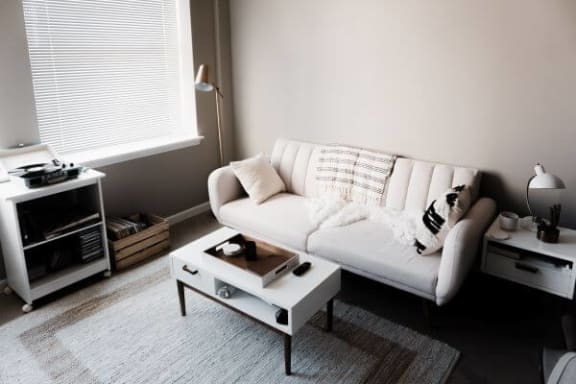 a living room with a white couch and a white coffee table