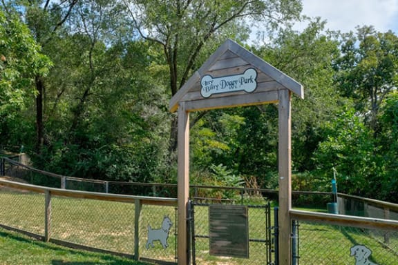 a park with a gate and a sign