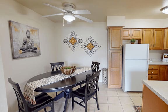 A dining room with a table and chairs.