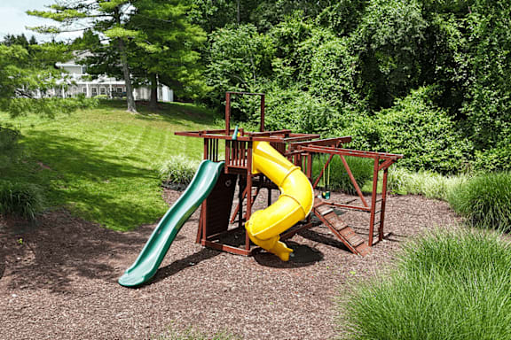 A yellow slide in a playground.