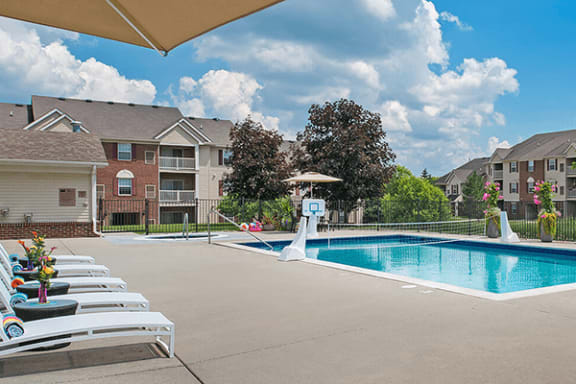 Pool available with chairs and umbrella in Holly, Michigan