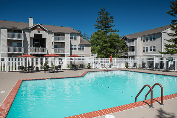 a swimming pool in front of an apartment building
