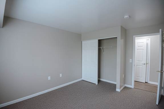 A room with a carpeted floor and white walls.