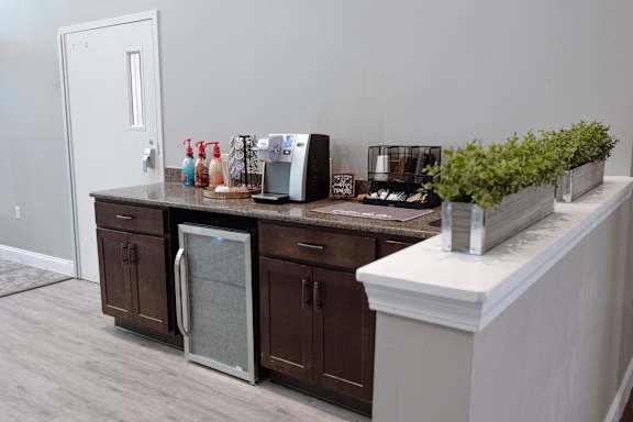 A kitchen with brown cabinets and a white counter.