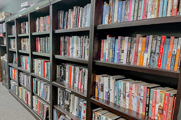 A bookshelf filled with a variety of colorful books.