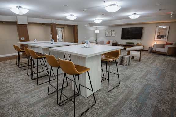 A conference room with a long table and chairs.