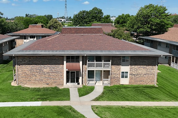 A building with a red roof and a walkway in front.