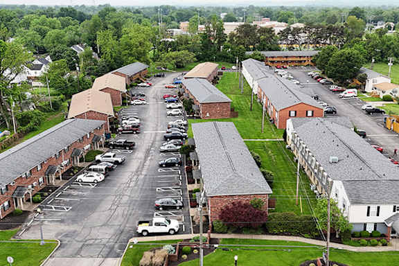 A parking lot with cars and a building in the background.