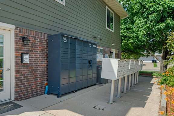 A long white box is on the sidewalk in front of a house.