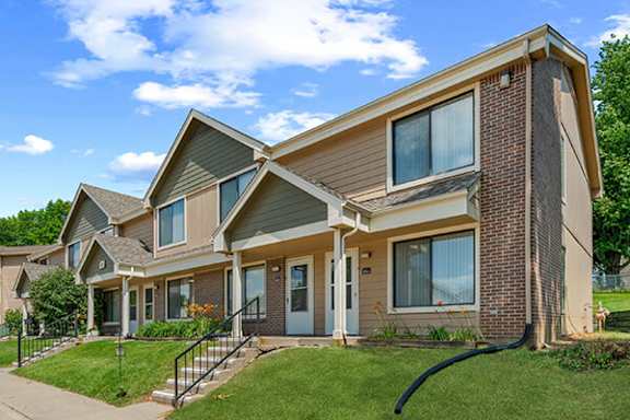 A row of houses with a blue sky in the background.