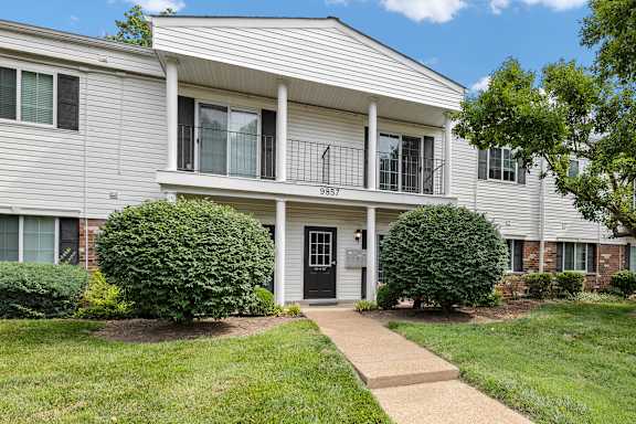 A house with a front yard and a walkway leading to the front door.