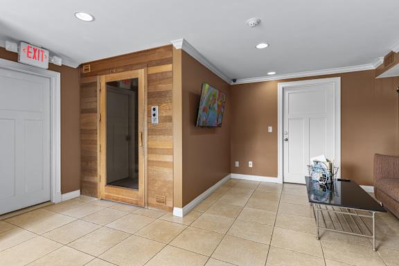 A room with a glass door and a white door.