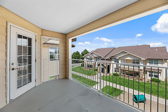 A balcony with a view of a residential area.