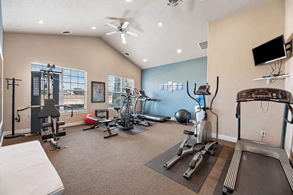 A spacious home gym with a variety of exercise equipment.