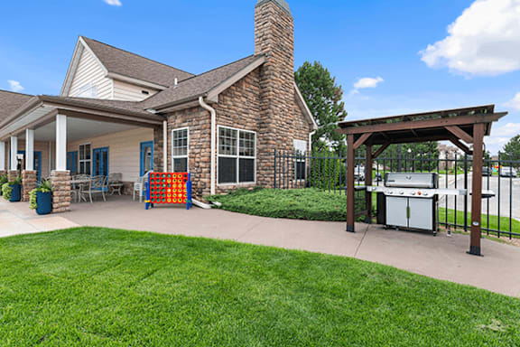 A house with a white porch and a brown brick chimney.