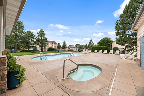 A pool with a hot tub in the middle of it.