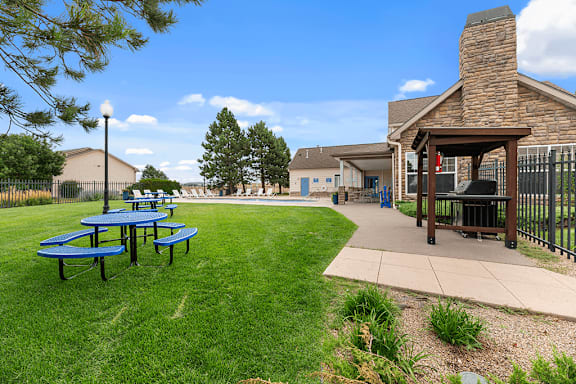 A park with a picnic table and a pavilion.