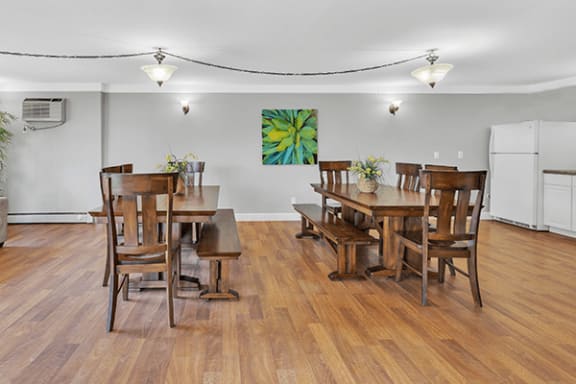 a dining room with a wooden table and chairs