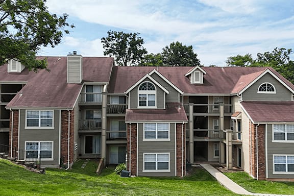 Apartment complex with multiple buildings and balconies.