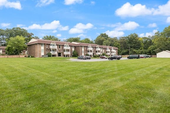 a large lawn in front of an apartment building