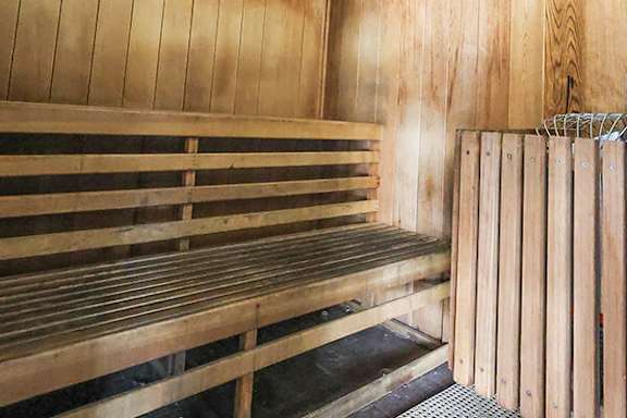 A sauna with wooden benches and walls.