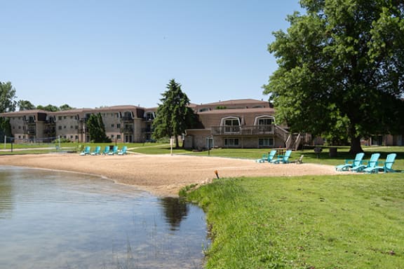 a beach in front of lamberton lake apartments