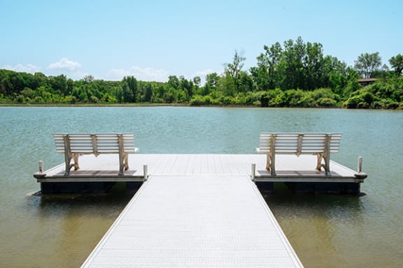 two benches on a dock in the water at lamberton lake