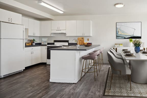 a kitchen and dining room with white cabinets and a table and chairs
