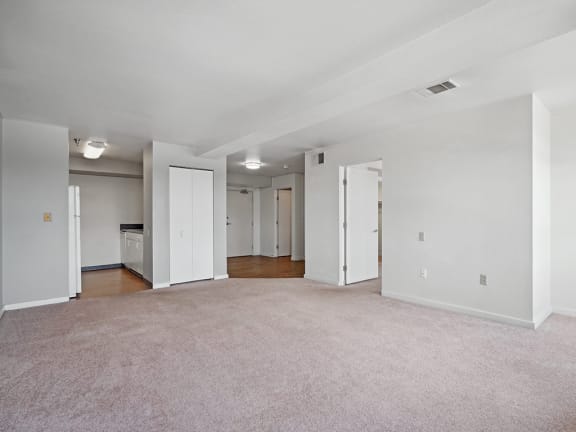 an empty living room with white walls and a carpeted floor