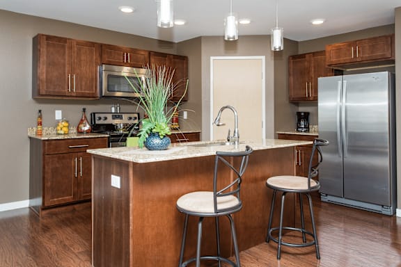 A kitchen with a bar stool and a counter.